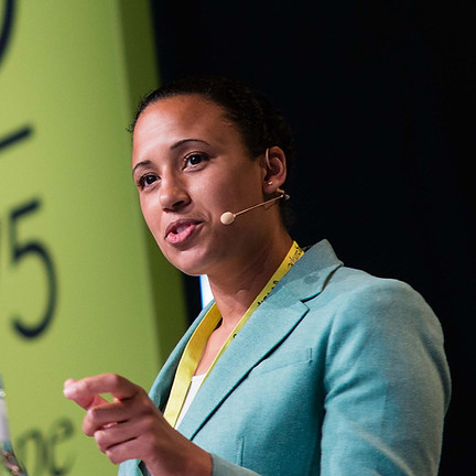 Nani Jansen Reventlow, a black woman, dynamically speaks before a crowd.